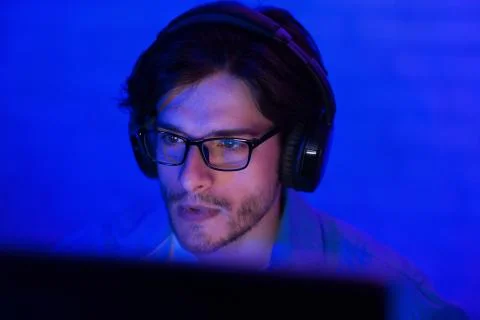 Professional Developer Man Working On Desktop Computer In Office, Low-Light Stock Photos