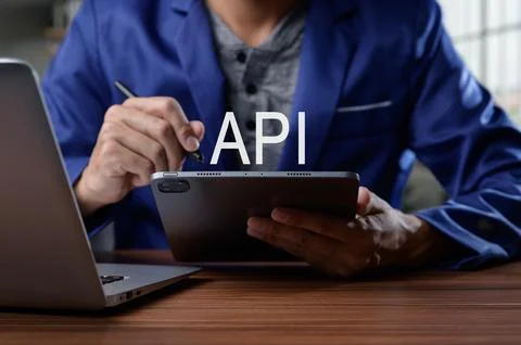 Professional Developer Working on API Integration with Tablet Device Foto stock