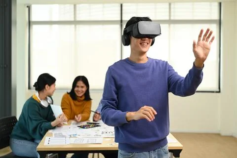 Professional developers testing virtual reality simulator glasses at meeting Stock Photos
