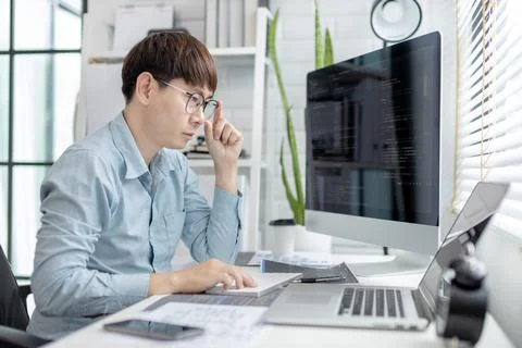 Professional development programmers are sit on a desk with work equipment su 스톡 사진