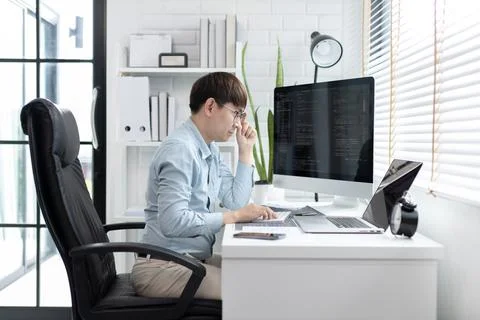 Professional development programmers are sit on a desk with work equipment su Stock-Fotos