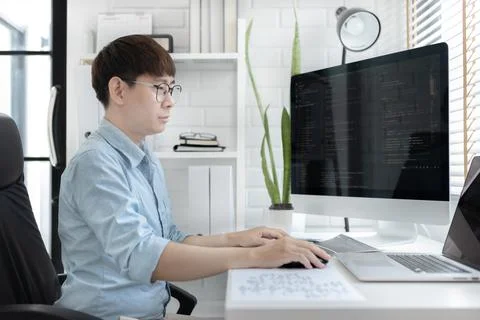 Professional development programmers are sit on a desk with work equipment su 库存照片