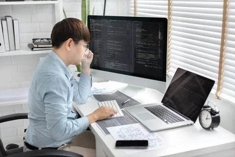 Professional development programmers are sit on a desk with work equipment su 스톡 사진