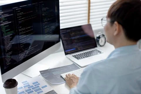 Professional development programmers are sit on a desk with work equipment su 库存照片