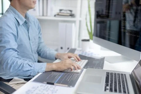 Professional development programmers are sit on a desk with work equipment su Stock Photos