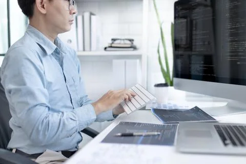Professional development programmers are sit on a desk with work equipment su 库存照片