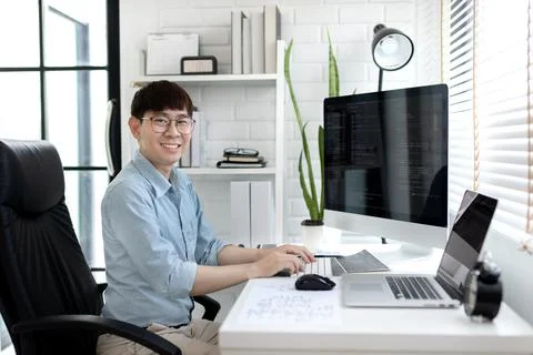 Professional development programmers are sit on a desk with work equipment su 库存照片