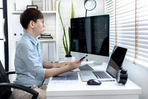 Professional development programmers are using mobile phones to test the func 스톡 사진