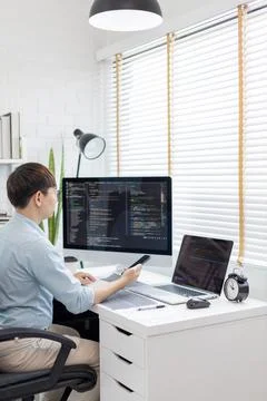 Professional development programmers are using mobile phones to test the func Stock Photos