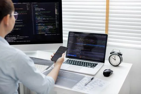 Professional development programmers are using mobile phones to test the func 스톡 사진