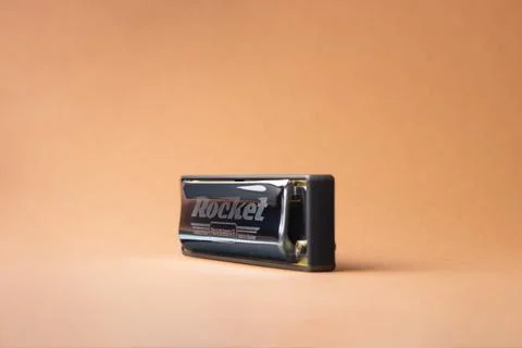 Professional diatonic harmonica Hohner Rocket stands sideways On a light brow Stock Photos