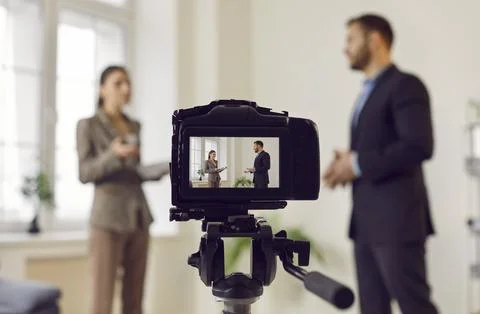 Professional digital camera recording live podcast video interview of young man Stock Photos