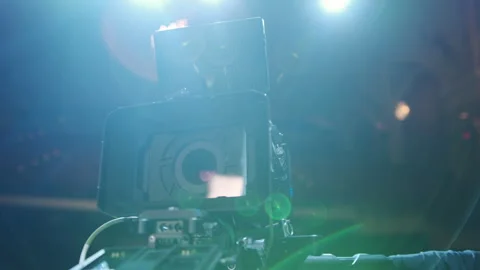 Professional digital cinema camera with set of light hanging in studio Stock Footage 243199652