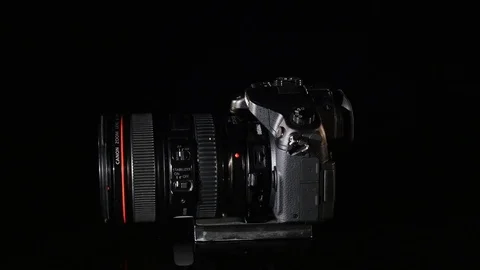 Professional digital photo camera rotate on black background Stock Footage 75669066