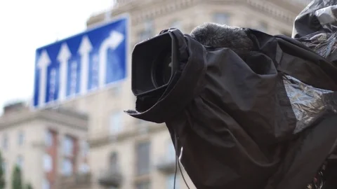 Professional digital TV camera in a waterproof cover at work Stock Footage 79341779