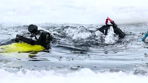 Professional diver in a diving suit, helmet and gear, ready to dive for und.. Stock Footage 321241612