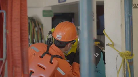 Professional diver preparing for underwater work with assistance from a support Stock Footage 346651715