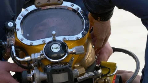 A professional diver is wearing a heavy diving helmet. Stock Footage 141526196