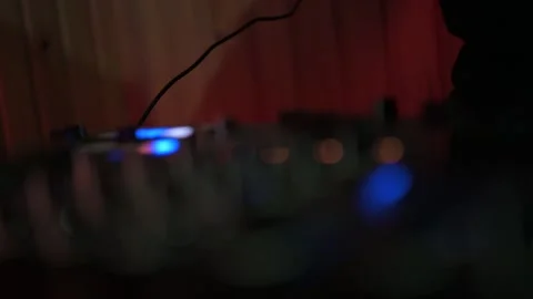Professional dj adjusting knobs and pressing buttons on a sound mixer controller Stock Footage 327684442