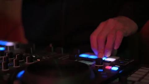 Professional dj hands mixing and scratching on a turntable controller, creating Stock Footage 327684520