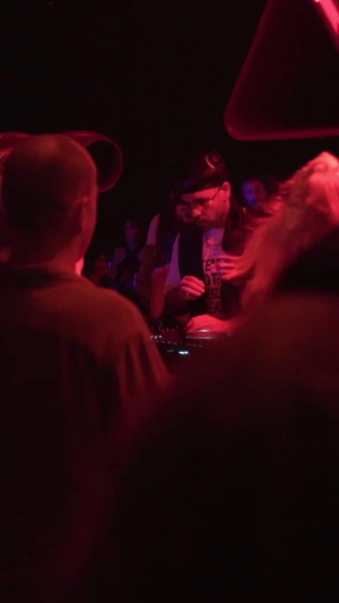Professional DJ Performing Live Behind Crowd at Beach Club Night Party. Stock Footage 337902901