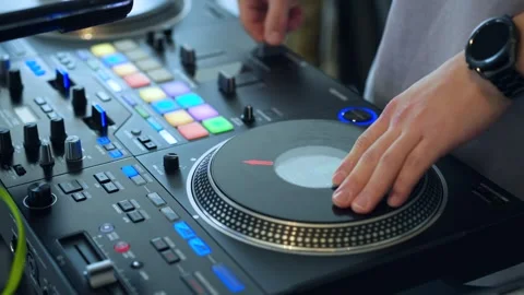 Professional DJ Scratching on Turntable Controller With Colorful RGB Pads Stock Footage 332187190