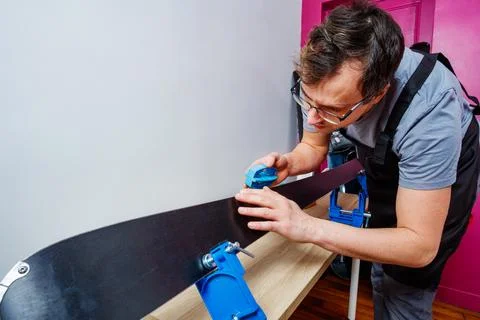 Professional do maintenance of ski sharp edge with care in vises Stock Photos