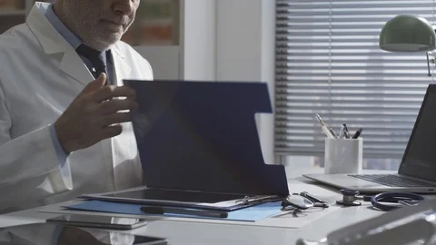 Professional doctor checking a patient's medical records Stock Footage 127368053