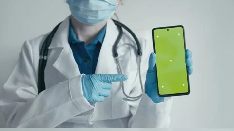 A professional doctor demonstrates on smartphone the website of the clinic with Stock Footage 252132896