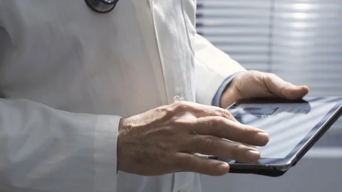 Professional doctor using a digital tablet and working Stock Footage 127368172