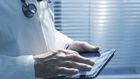 Professional doctor using a digital tablet and working Stock Footage 127368215