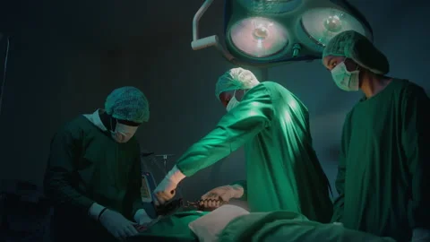 Professional doctors in the operating room making  CPR and use defibrillator  Stockbeeldmateriaal 195209586