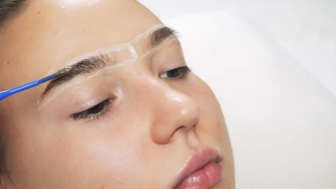 A professional does dyeing eyebrows with dyes, tinting. Stock Footage 121943237