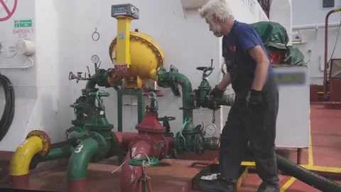 Professional donkeyman controls fuel pumping rotating valves Stock Footage 147171492