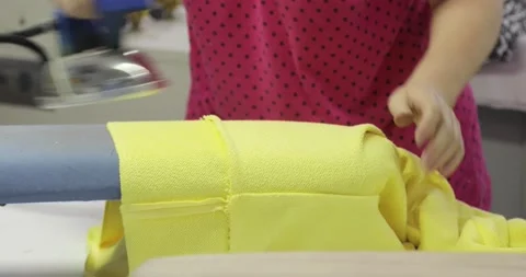 Professional dressmaker ironing clothes, the process of sewing clothes in a Stock Footage 157365057
