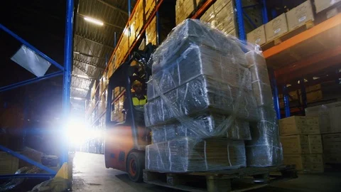 Professional Driver Operates Forklift Truck with Cargo in Big Warehouse. Stock Footage
