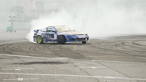 Professional driver performing a high-speed drift in a modified sports car Stock Footage 338430112