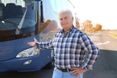 Professional driver standing near bus. Passenger transportation Stock Photos