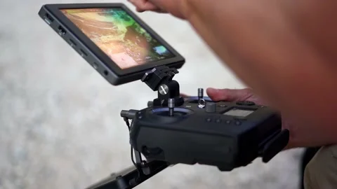 Professional drone pilot flying with controller Stock Footage 156077949