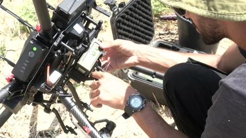 Professional drone pilot or stock photographer prepares a Drone for Flight. Stock Footage 139487269