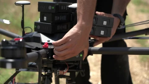 Professional drone pilot or stock photographer prepares a Drone for Flight. Stock Footage 139487312