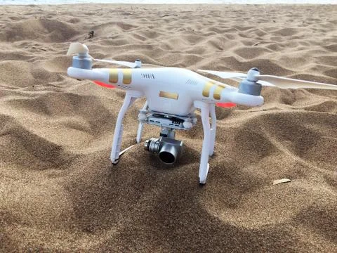 Professional drone quadcopter with digital camera on tropical beach Stock Photos