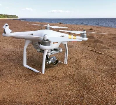 Professional drone quadcopter with digital camera on tropical beach Stock Photos