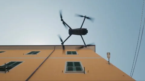 Professional drone taking off low angle shot, urban building background Stock Footage 339077631
