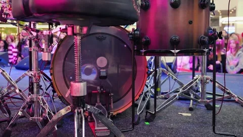 Professional drum kit and vocal microphones set up on an empty stage in a mall. Stock Footage 329141103