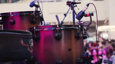 Professional drum kit and vocal microphones set up on an empty stage in a mall. Stock-Footage 329141312