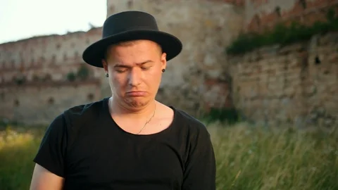 Professional drummer, dressed in black hat, twists drumsticks, on the street Stock-Footage 114253653