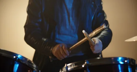 A professional drummer is playing rock music with band. Experienced musician is Stock Footage