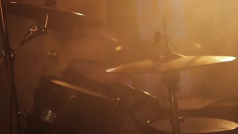 Professional drummer plays drum kit against smoke and lights on stage. Music Stock Footage 313891551