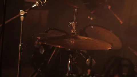 Professional drummer plays drum kit against smoke and lights on stage. Music Stockbeeldmateriaal 314427423